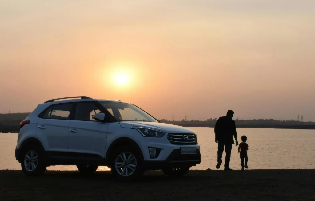 White SUV at sunset symbolising revised auto loan limits under Bangladesh Bank consumer financing policy